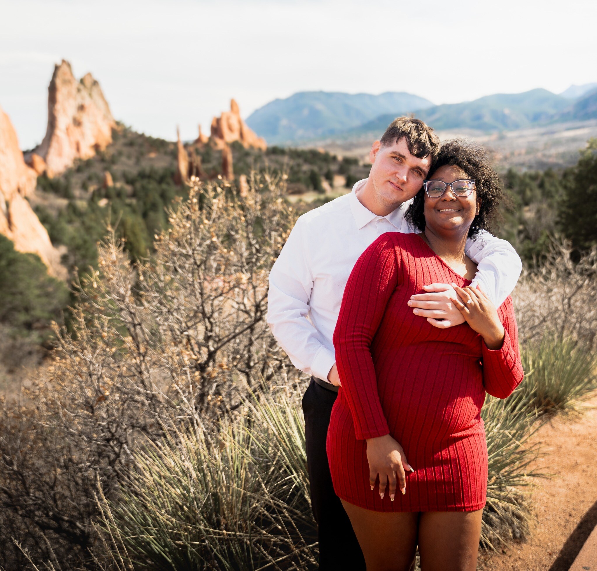 Engaged couple posing together at Garden of the Gods