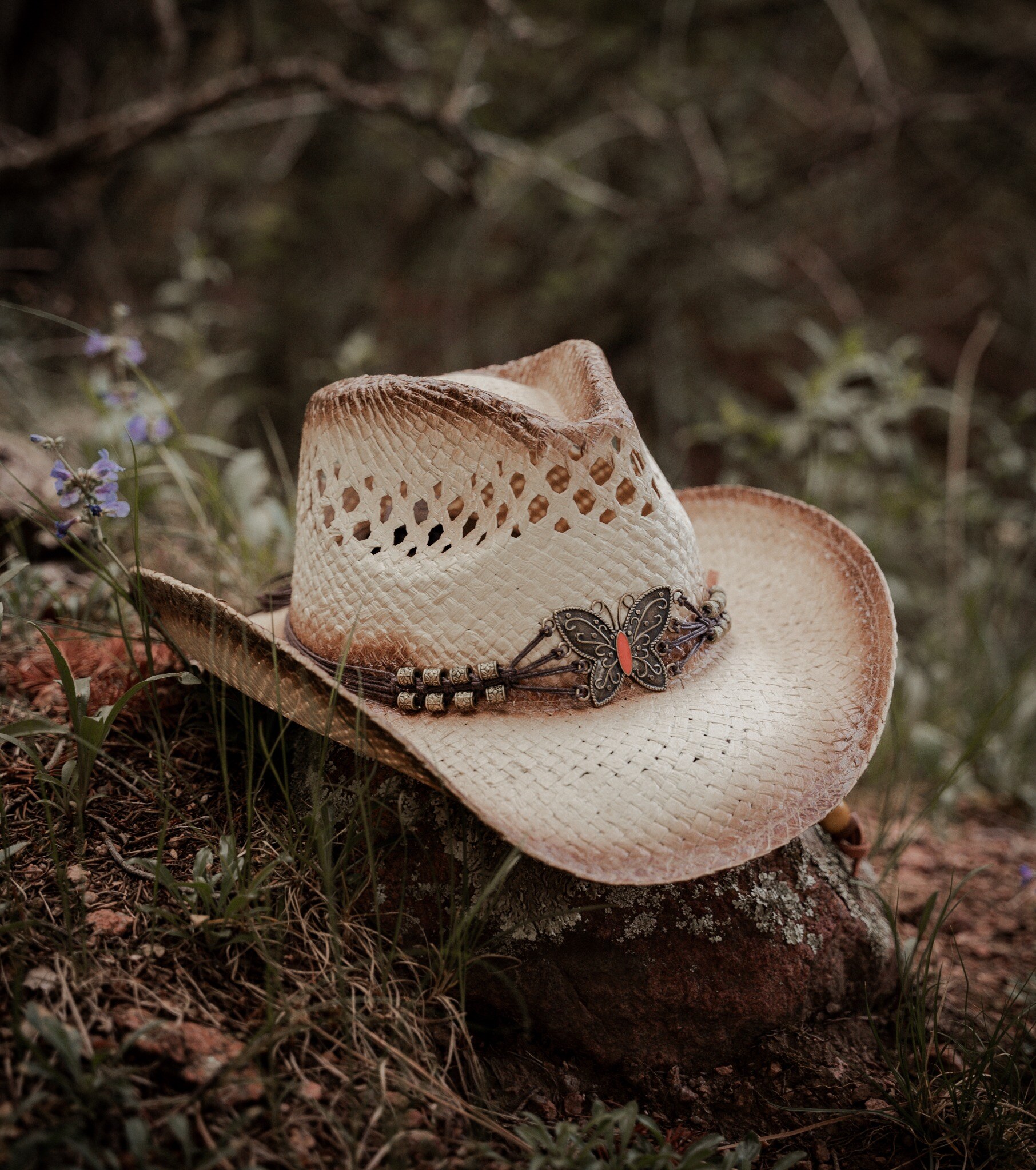 Western engagement detail featuring a butterfly cowboy hat