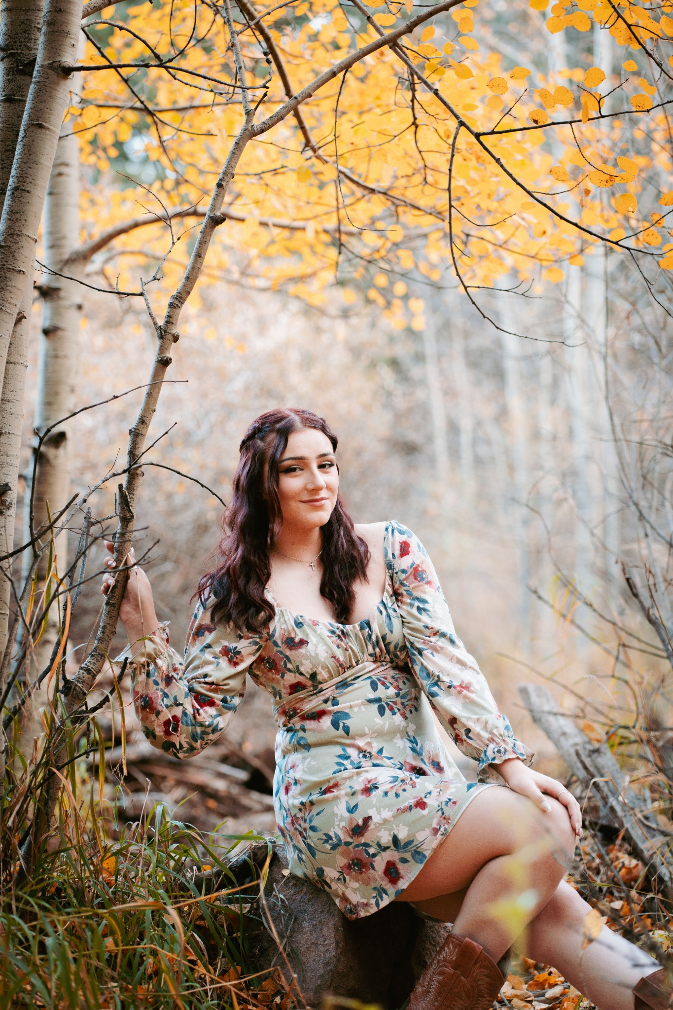 Senior portrait among golden autumn aspens