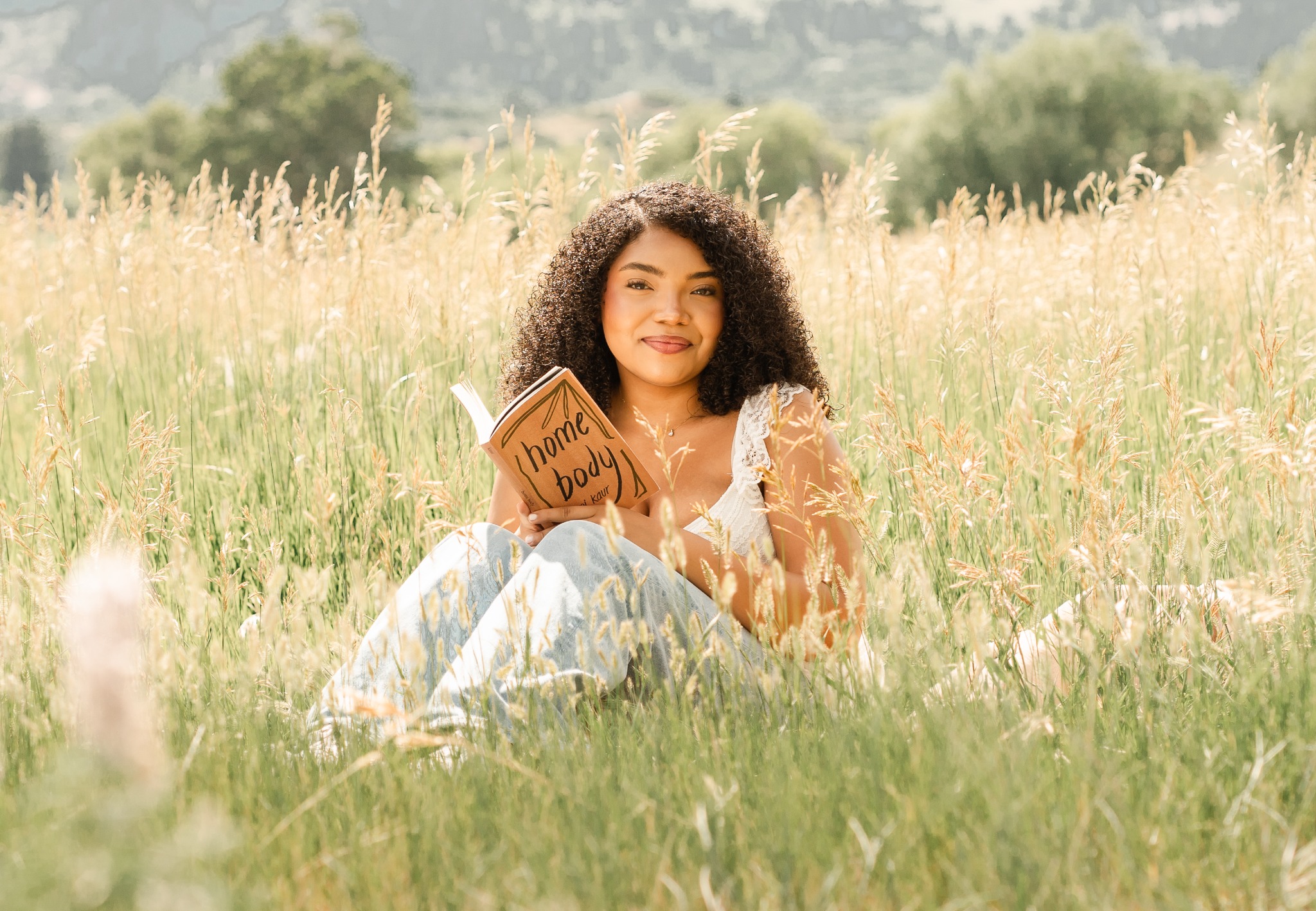 Senior portrait reading in a golden field