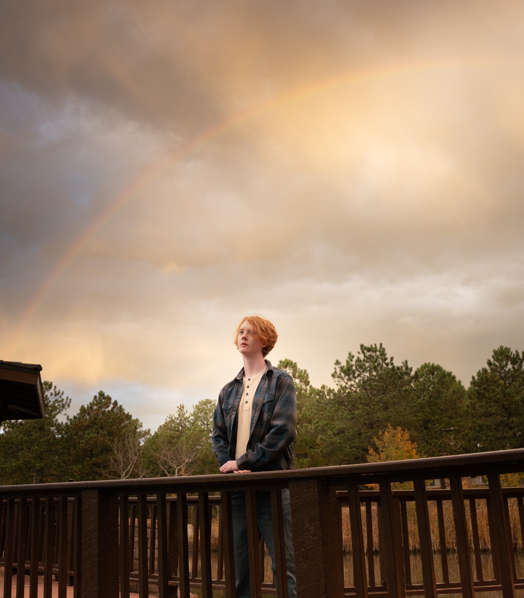 Senior portrait beneath a dramatic Colorado sky